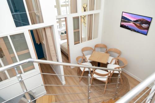 a balcony with a table and chairs in a room at Nets Inn Apartment - Gare de Lyon in Paris