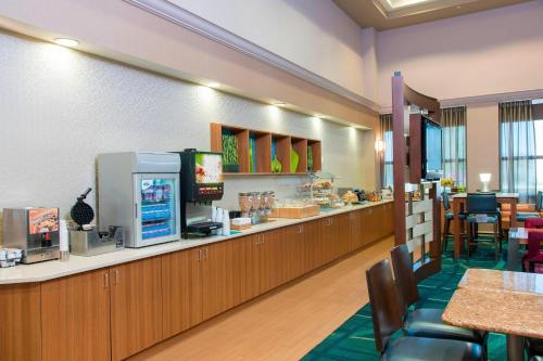 a fast food restaurant with a counter and tables and chairs at SpringHill Suites by Marriott Peoria in Peoria