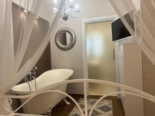 a bathroom with a white sink and a mirror at Fleur de Lys in Kikinda