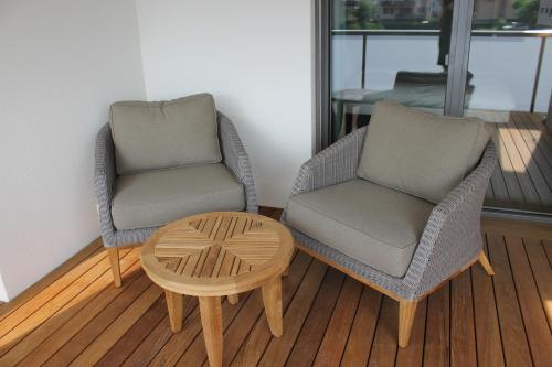 two chairs and a coffee table in a room at Residence Apartment in Vaduz