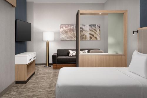 a hotel room with a bed and a couch at SpringHill Suites by Marriott Fayetteville I-95 in Fayetteville