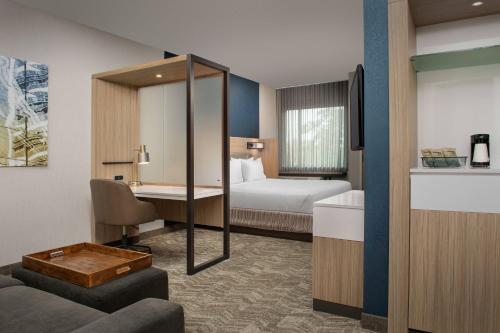 a hotel room with a bed and a desk at SpringHill Suites By Marriott Charleston Airport & Convention Center in Charleston