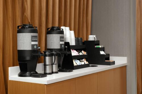 a table with a group of bottles and cups on it at SpringHill Suites By Marriott Charleston Airport & Convention Center in Charleston