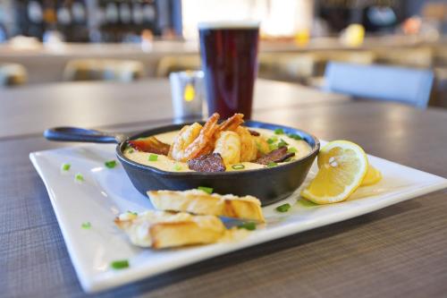 a bowl of food on a plate on a table at SpringHill Suites by Marriott Chattanooga North/Ooltewah in Ooltewah