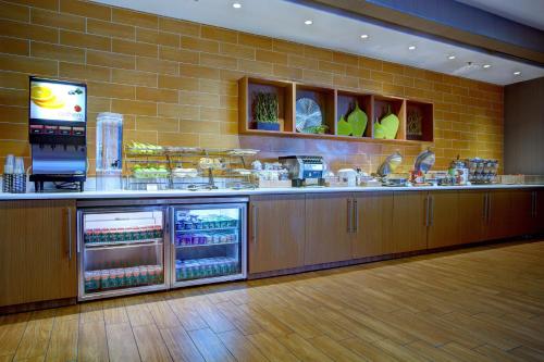 a restaurant kitchen with a counter with food at SpringHill Suites Harrisburg Hershey in Harrisburg