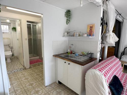 a small bathroom with a sink and a shower at Romantic Escape/ Cozy Delight in Brisbane
