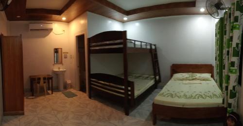 a bedroom with a bunk bed and a bunk bedouble at Dhong and Eden Home in San Vicente