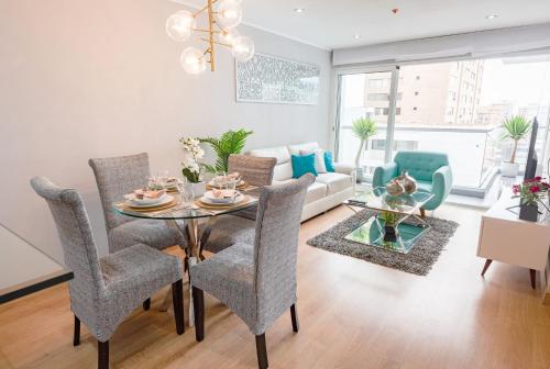 a living room with a table and chairs at Skyliving Towers Apartments - Perú in Lima