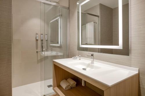 a bathroom with a sink and a shower at AC Hotel Som by Marriott in Hospitalet de Llobregat