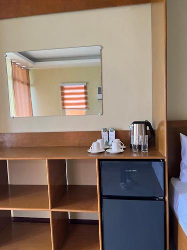 a room with a counter with a mirror and a sink at C View Resort in Sipalay