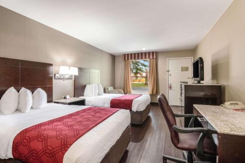 a hotel room with two beds and a television at Econo Lodge Pocomoke City Hwy 13 in Pocomoke City