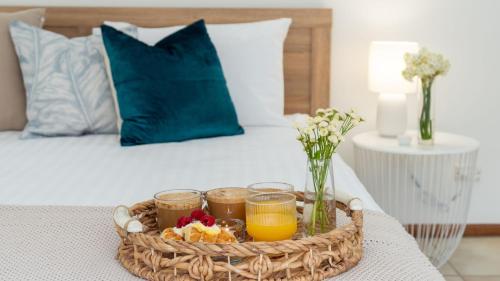 a tray of fruit and juice on a bed at Adelong in Kiama Downs