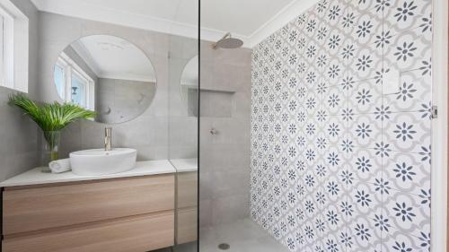 a bathroom with a sink and a mirror at Adelong in Kiama Downs