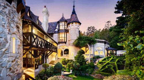 a castle style house with a garden in front of it at Thorngrove Manor in Stirling