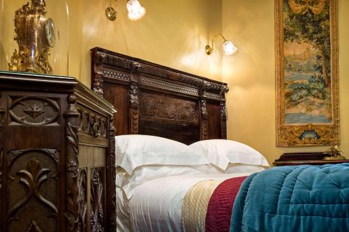 a bedroom with a large bed with white pillows at Thorngrove Manor in Stirling
