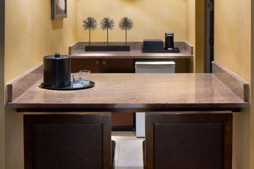 a kitchen with a counter with a coffee maker on it at The Lincoln Marriott Cornhusker Hotel in Lincoln