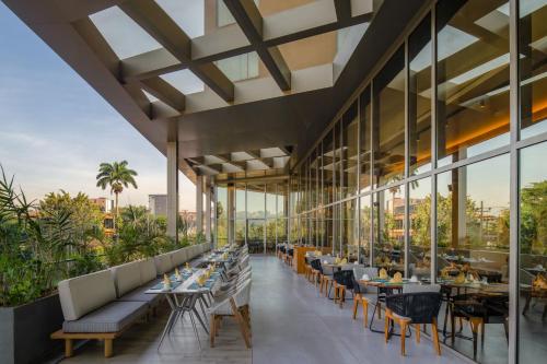 a restaurant with tables and chairs on a roof at Four Points by Sheraton Kampala in Kampala