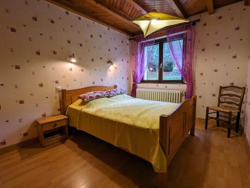 a bedroom with a bed and a window and a chair at Maison de Montagne à La Bresse, 2 Chambres, Confort et Activités, Garage, Wifi Inclus - FR-1-589-152 in La Bresse
