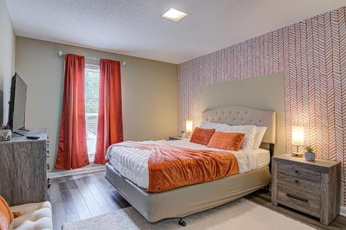 a bedroom with a bed with an orange blanket at Winston Salem Haven Near WFU in Winston-Salem