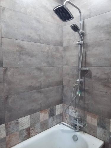a shower in a bathroom with a bath tub at The Kalavan Retreat Center in Chambarak