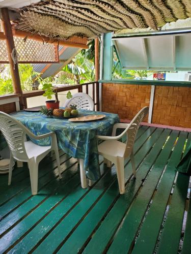 a table and chairs on the deck of a house at Fare Te ava Fitii in Fitii