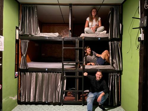 a group of people sitting on top of bunk beds at Topp paiway hostel in Pai