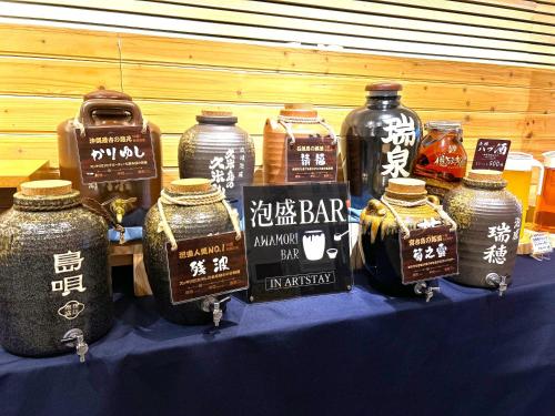 a table with jars of honey on a blue table at Hotel Art Stay Naha Kokusai-Dori in Naha