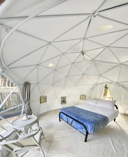 a bedroom with a bed in a tent at Eco Glamping Treehouses Closest Resort To All Tourist Attractions in Balilihan
