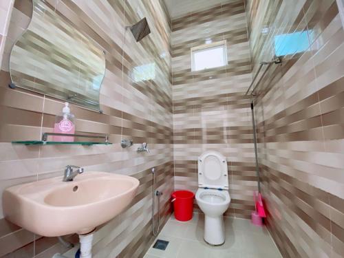 a bathroom with a sink and a toilet at Roomstay HELLOKITTY HOUSE in Kuala Terengganu