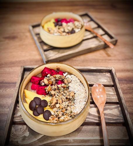 two bowls of food sitting on a wooden table at Paddy Boutique House Hoian in Hoi An
