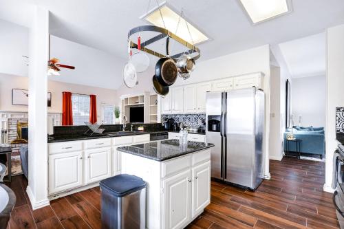 a kitchen with white cabinets and a stainless steel refrigerator at Nr Sea World Games WiFi BBQ Yard Pet Ok in San Antonio