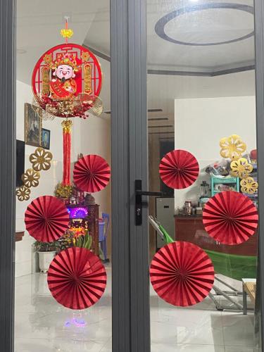 a door with red umbrellas in a room at Homestay Tuyết Trinh in Nha Trang