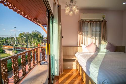 a bedroom with a bed on a balcony at Ratana Boutique Resort - Mae Phim in Ban Ang