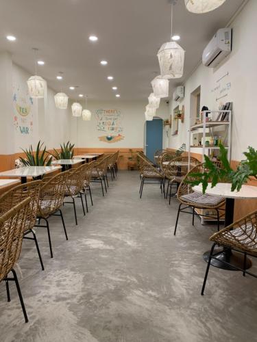 a row of tables and chairs in a restaurant at The Nest Homestay in Ho Chi Minh City
