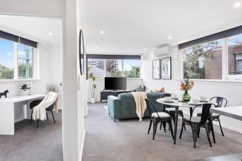 a living room and dining room with a table and chairs at Charnwood 2BR: Homely Haven in Melbourne