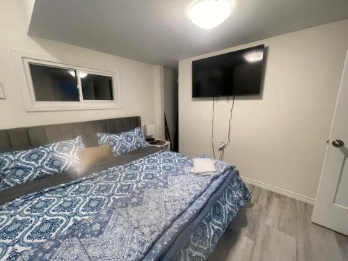 a bedroom with a bed and a flat screen tv at Janis Guest House 6-8 Guests in Wilberforce