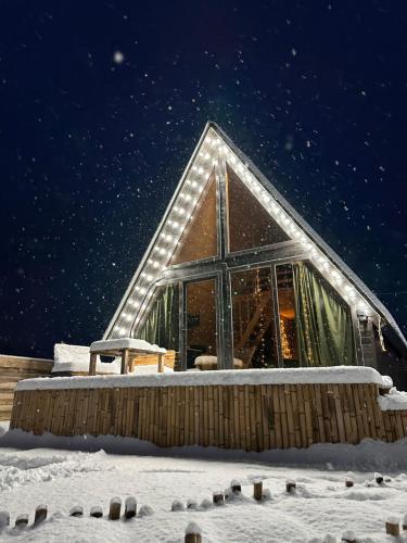 a building with lights on it in the snow at Cozy Hills in Borjomi