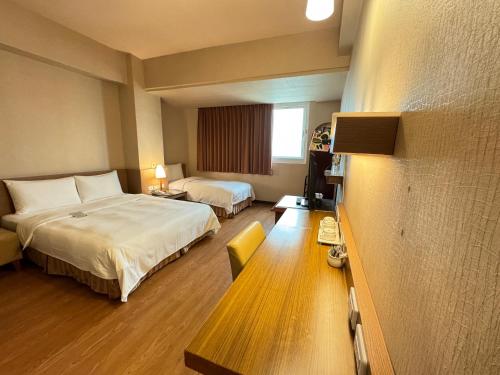 Giường trong phòng chung tại Kindness Hotel Wu-Jia