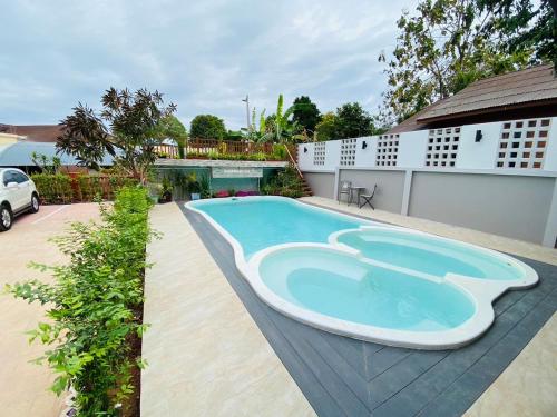 a swimming pool in the backyard of a house at Ratana Boutique Resort - Mae Phim in Ban Ang