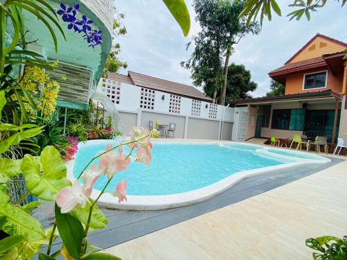 a swimming pool in the backyard of a house at Ratana Boutique Resort - Mae Phim in Ban Ang