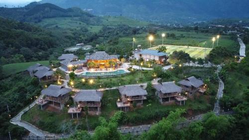an aerial view of a mansion with a resort at Mường Lò Retreat Nghia Lo in Yên Bái
