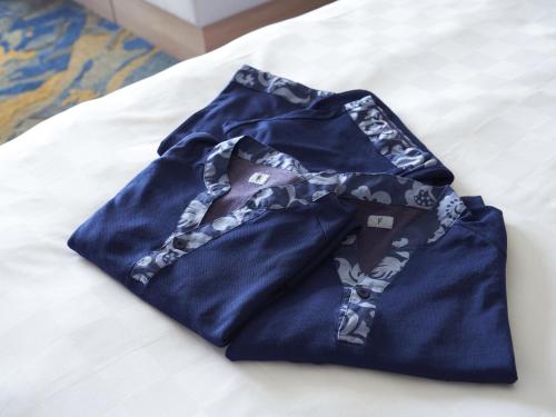 Postel nebo postele na pokoji v ubytování Okinawa Prince Hotel Ocean View Ginowan