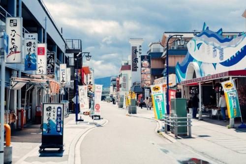 a city street with many signs and buildings at 沼津戸田湾の古民家一軒貸切宿 釣り ハイキング 海水浴 ツーリングにおすすめ in Toda