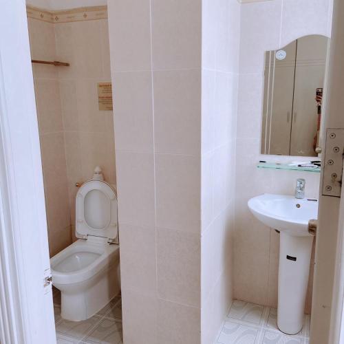 a bathroom with a toilet and a sink at MILAND HOTEL in Can Tho