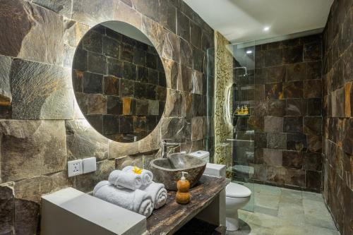 a bathroom with a sink and a mirror at Brand new Luxury 3BR villa Ethnic Ubud #3 in Ubud