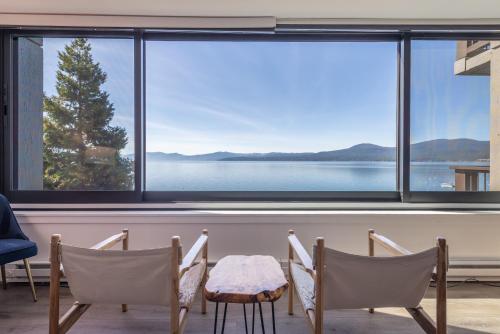a room with a table and chairs and a large window at VIP Lakefront Condo Amazing Views Pool Pickleball Excellent Location Balcony BBQ in Kings Beach