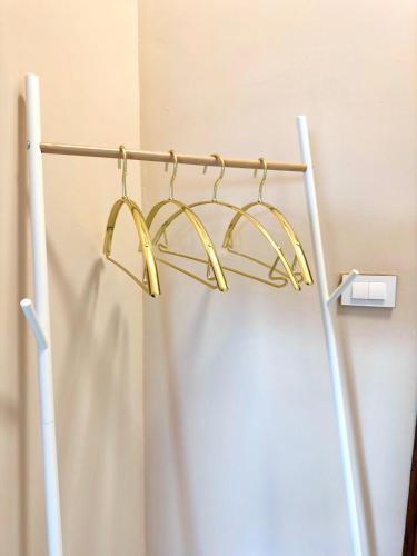 a gold towel rack hanging on a wall at NuNc in Kenting