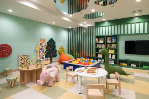 ein Kinderspielzimmer mit einem Tisch und Stühlen in der Unterkunft Nozo Hotel in Furano