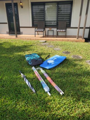 a group of baseball equipment laying on the grass at Cozy family home in quiet area, nice garden views. in Tamiami