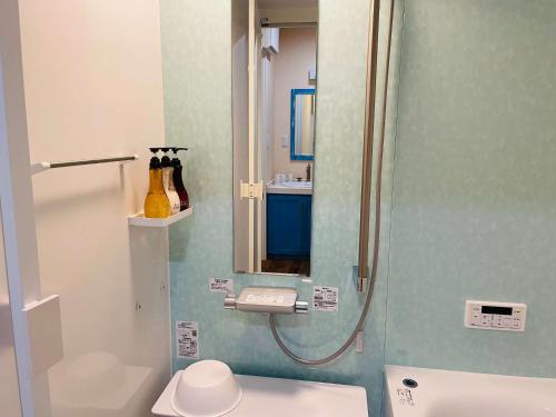 a bathroom with a shower with a toilet and a sink at La Classe Angel Road 2 - Vacation STAY 71507v in Fuchisaki